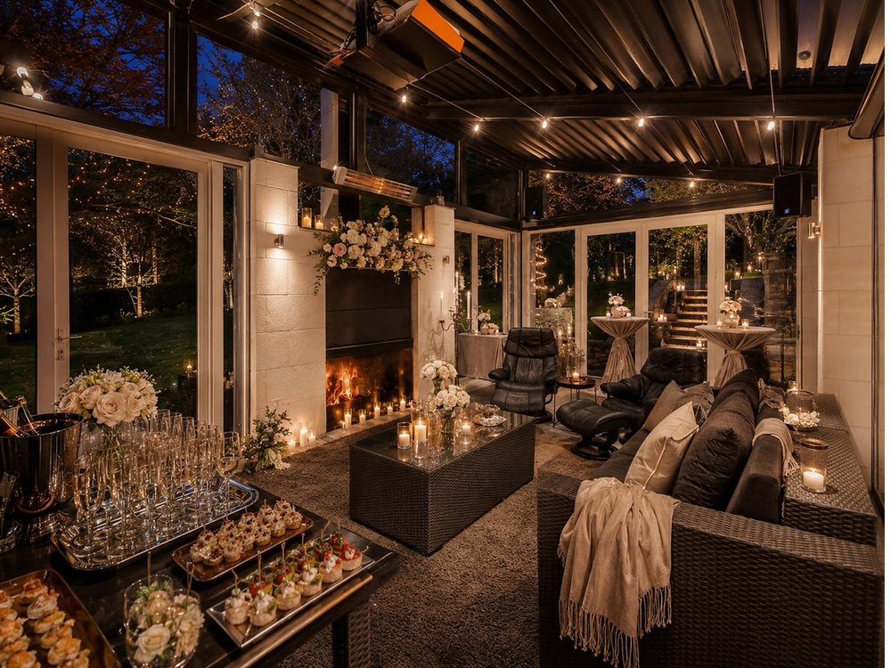 The outdoor lounge and fireplace at Mishika Retreat at dusk