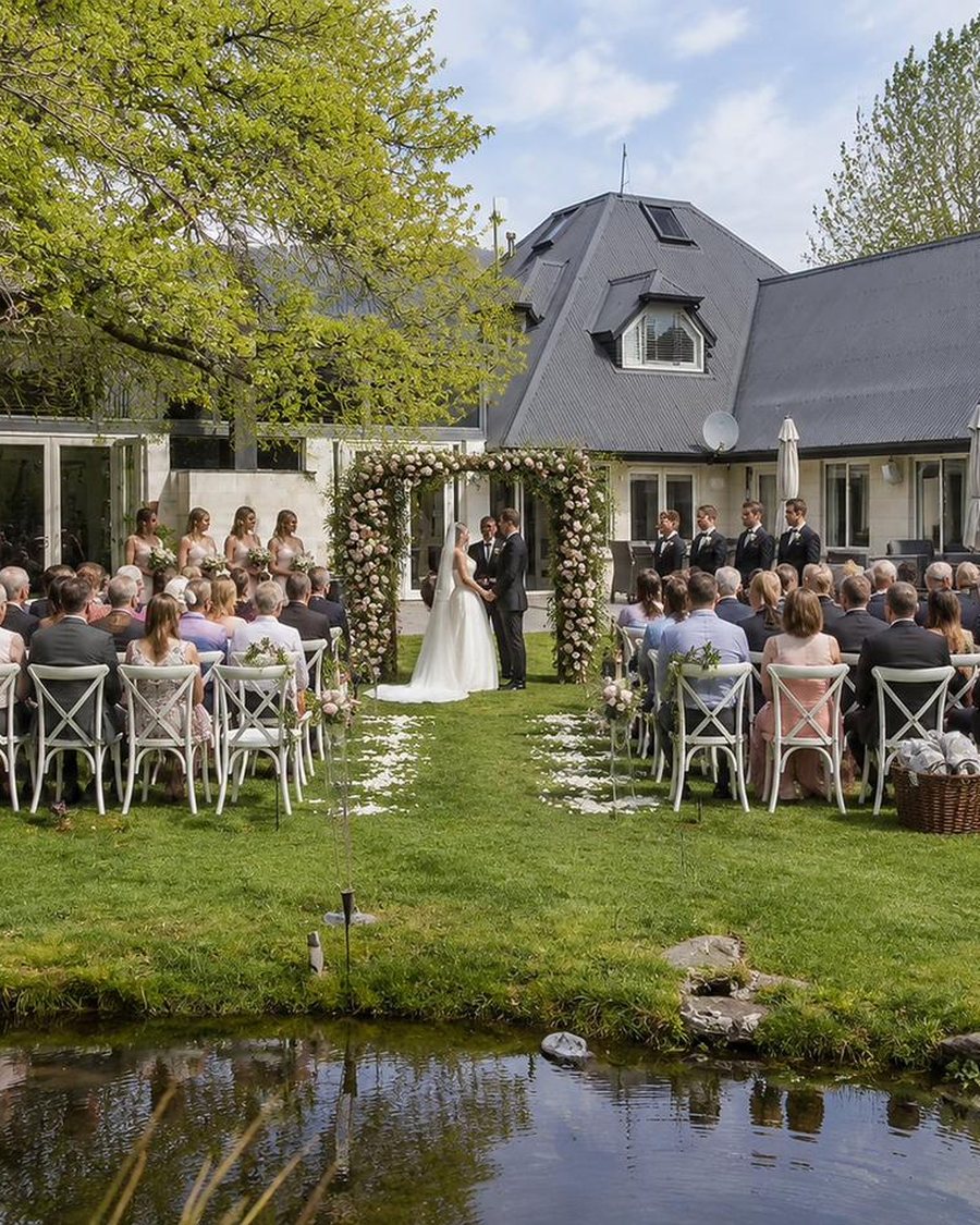 A garden wedding ceremony set in the grounds of Mishika Retreat, Wānaka
